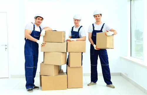 Professional movers carrying furniture through a residential property
